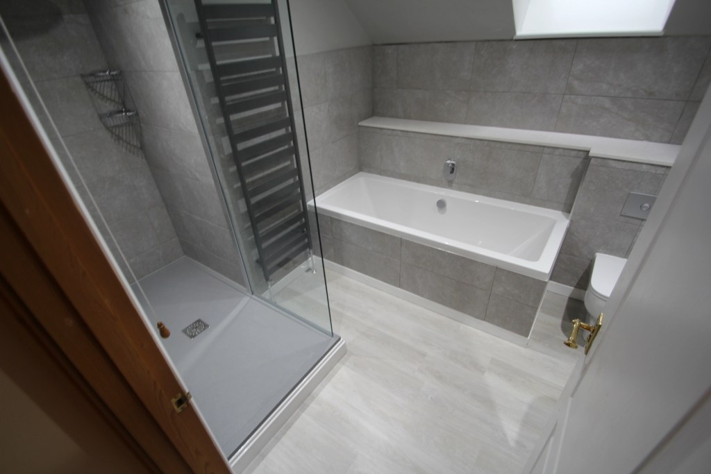 Separate bath and shower in completed bathroom
